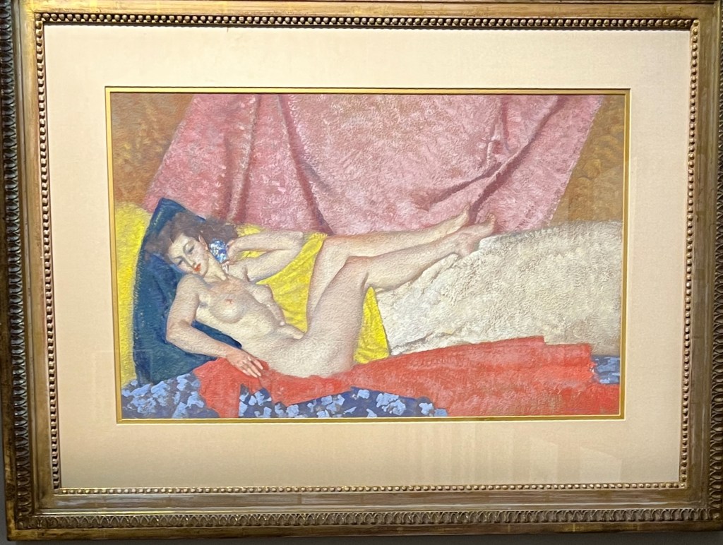 Painting by Sir William Russell Flint called Gabrielle. It depicts a nude lady reclining on a red sheet against a blue pillow, on a  yellow piece of furniture, with a large pink curtain in the background.