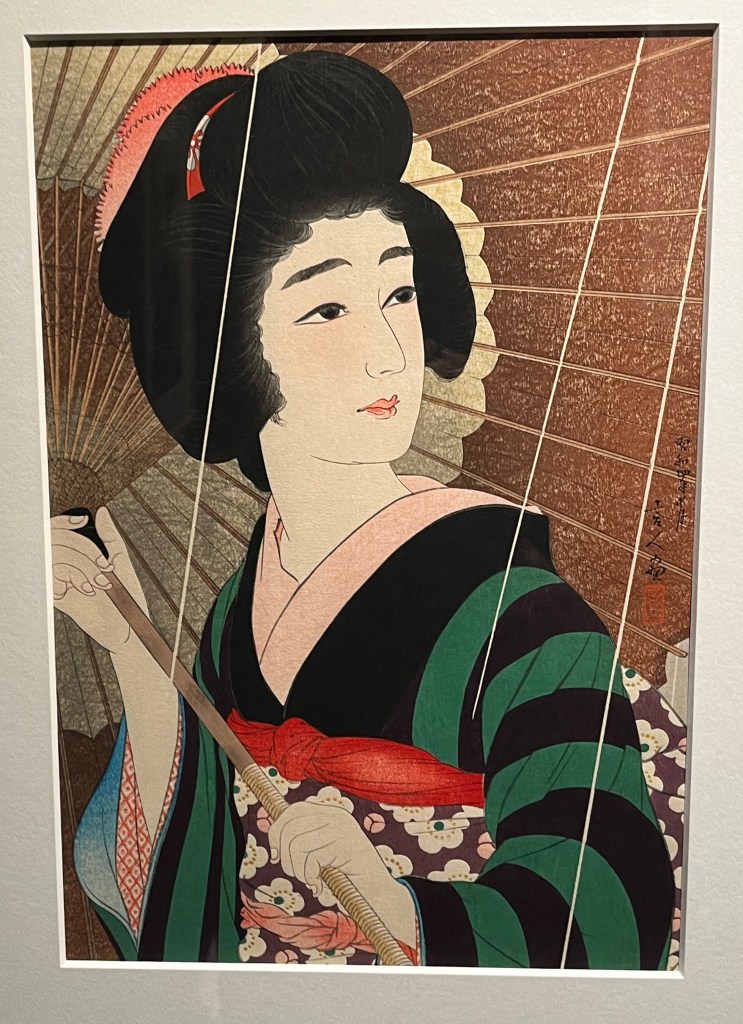 Woodblock print that depicts a gracefully dressed young woman walking in the rain under the shelter of a waxed paper umbrella.