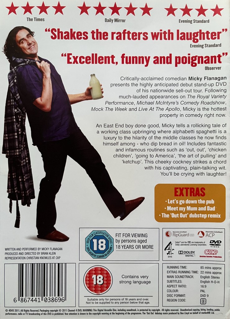 Back cover of the DVD for Micky Flanagan, The Out Out Tour Live. Alongside a description of the DVD and list of extra features is a picture of Micky walking along jauntily with a bottle of milk in one hand, while his other hand is hooking a dressing gown over his back.