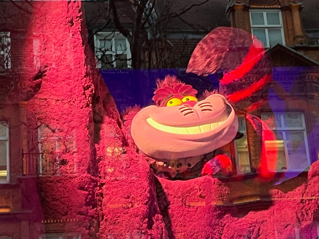 Close-up of the grinning Cheshire cat in a Selfridges window display representing Alice In Wonderland.