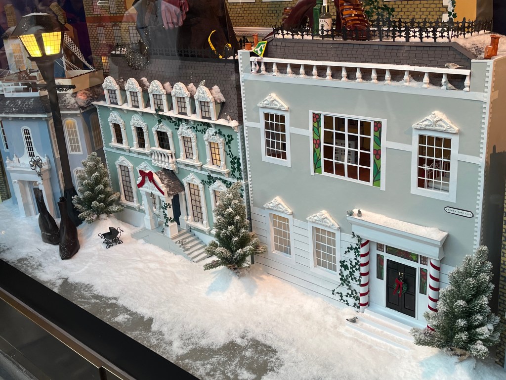 Close-up of a detailed model of a street in the snow, from a Selfridges window display representing Mary Poppins.