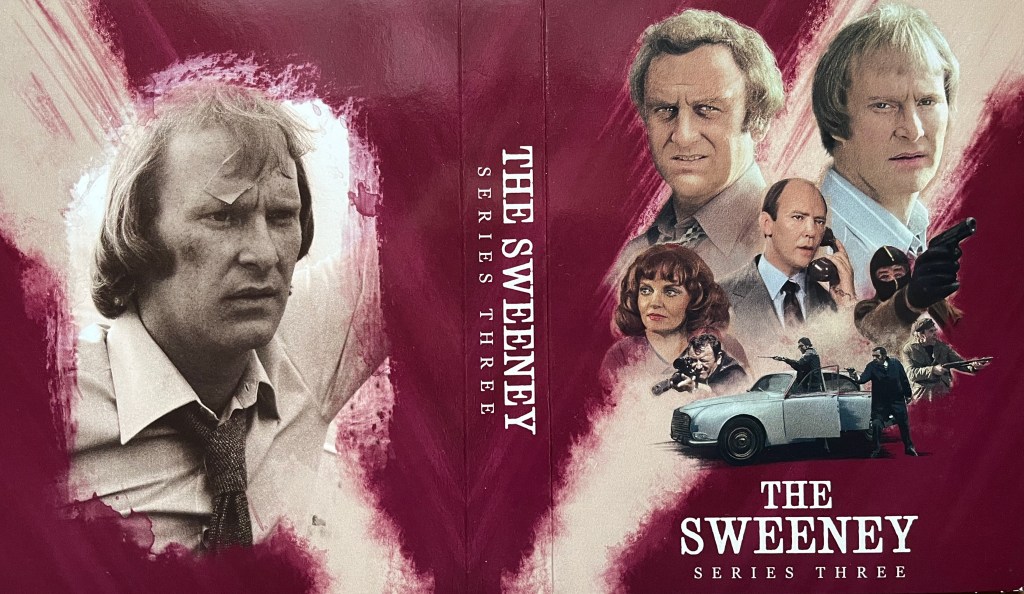 Cover spread for the inner box for The Sweeney Series 3 on Blu-ray, with a red background behind the imagery and text. On the right is a large colour image of Regan and Carter, played by John Thaw and Dennis Waterman. Below them are images from the series including Haskins on the phone, several men holding guns, and a female character from the series. On the left is a black and white photo of Carter wearing a shirt and tie, with a bruise on his cheek and a plaster on his forehead. The thick spine in between the two panels says The Sweeney, Series Three.
