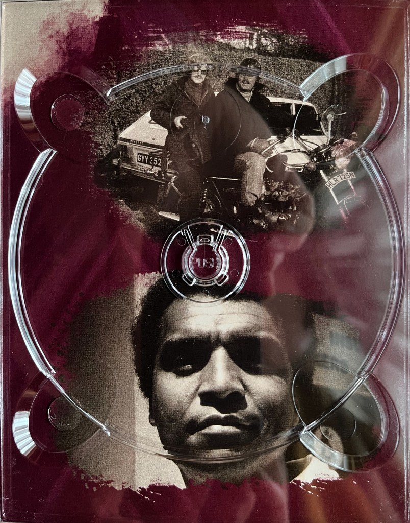 Two black and white photos. The top one shows two men on a motorbike, with the guy on the back holing a shotgun, while bottom image shows a close-up of a man's face with a serious expression. The images are placed on a red background, and are from one of the panels in the Blu-ray box set for The Sweeney Series 3.