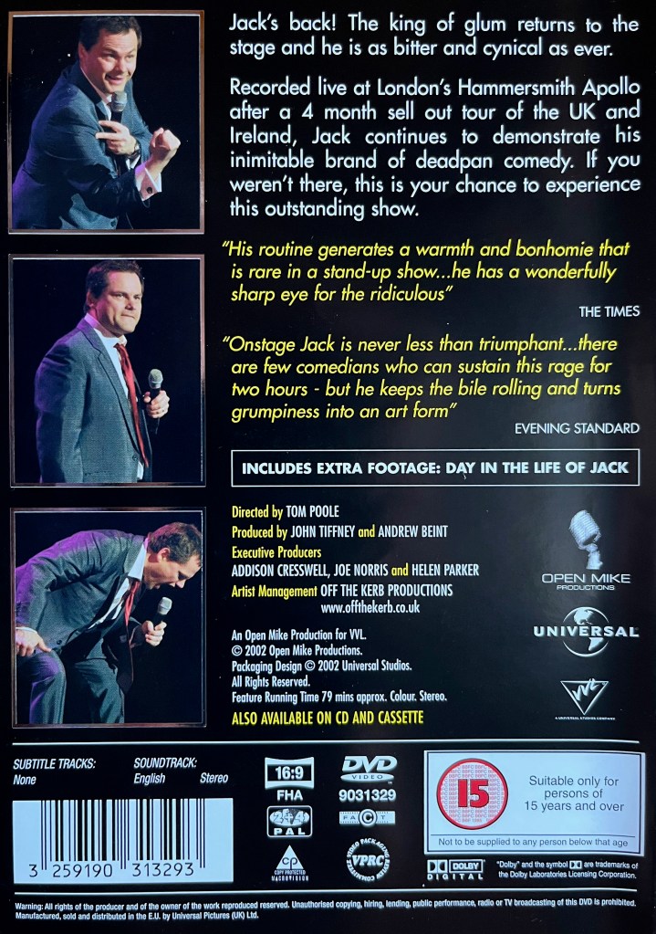 Back cover of the DVD for Jack Dee Live At The Apollo, with a black background. The description and credits on the right are alongside 3 images of Jack performing on stage on the left, while the technical and copyright information is across the bottom.