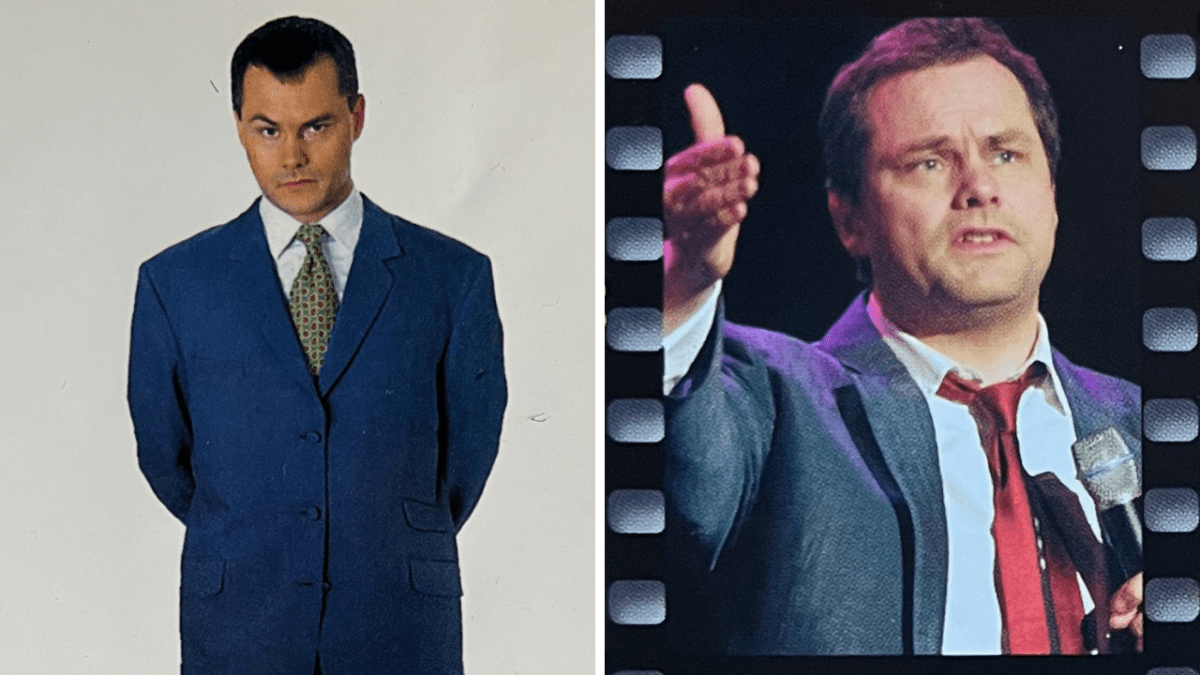 Two photos of comedian Jack Dee. On the left, he is standing against a white background, wearing a blue suit over a patterned tie and a white shirt. On the right, against a black background, he's talking into a microphone and gesturing with his hand while wearing a grey jacket over a red tie and white shirt.