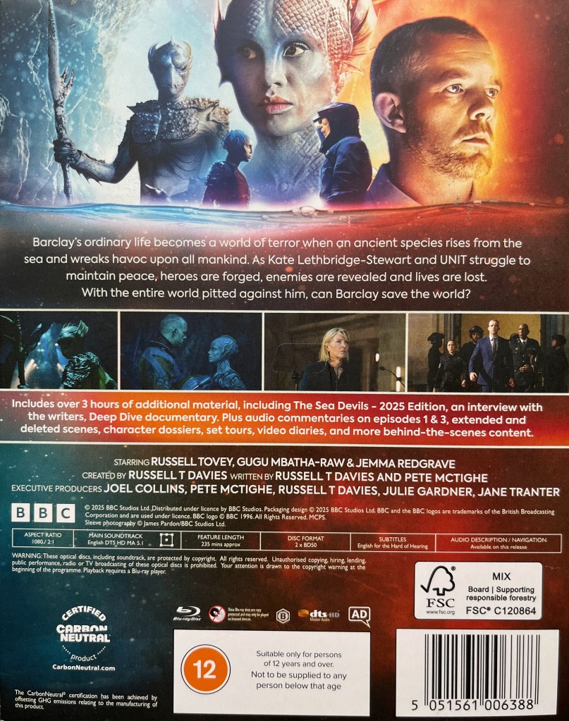 Back cover of the Blu-ray for The War Between The Land And The Sea. At the top of the cover is imagery of human Barclay and sea creature Salt, along with another of the Sea Devils. Below that is a short description of the series, followed by a horizontal block of 4 more images from the show, including Barclay, Salt, UNIT commander Kate Lethbridge-Stewart and other members of the UNIT team. Then below that is a list of extra features, credits and technical information.
