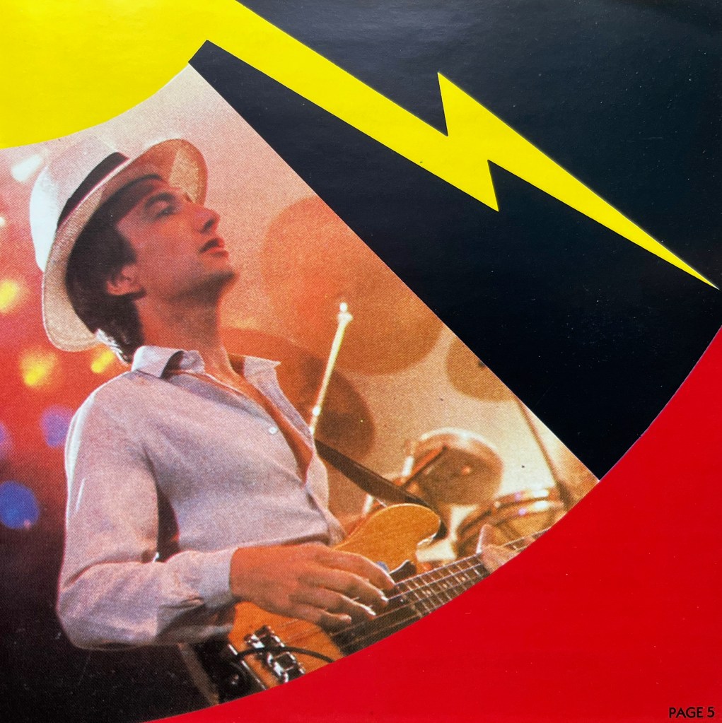 A photo of John Deacon playing bass guitar from the booklet with the Flash Gordon album, with a yellow streak of lightning above him.