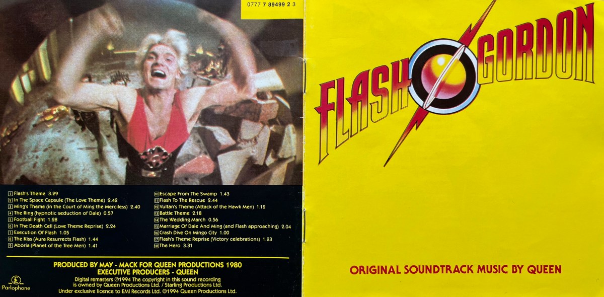 Cover spread for the Queen soundtrack album Flash Gordon. The front cover on the right has the Flash Gordon logo on top of a yellow background. The title is all in capital letters, which are each red at the top and yellow at the bottom, with a black outline. In between the words is a ringed planet in a circle, with 2 forks of lightning, coloured the same way as the letters, coming out of opposite sides of the circle. The back cover on the left, meanwhile, shows a photo of Flash from the film pumping his fists in the air above the track listing.