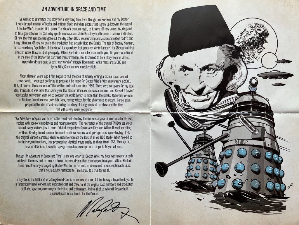 The inside double-page spread of the leaflet from the Blu-ray for the Doctor Who biographical drama An Adventure In Space And Time. On the left page is an introduction by Mark Gatiss, while on the right is a black and white artistic image showing the head of the first Doctor, and below him a couple of Daleks, with the moon in the background.