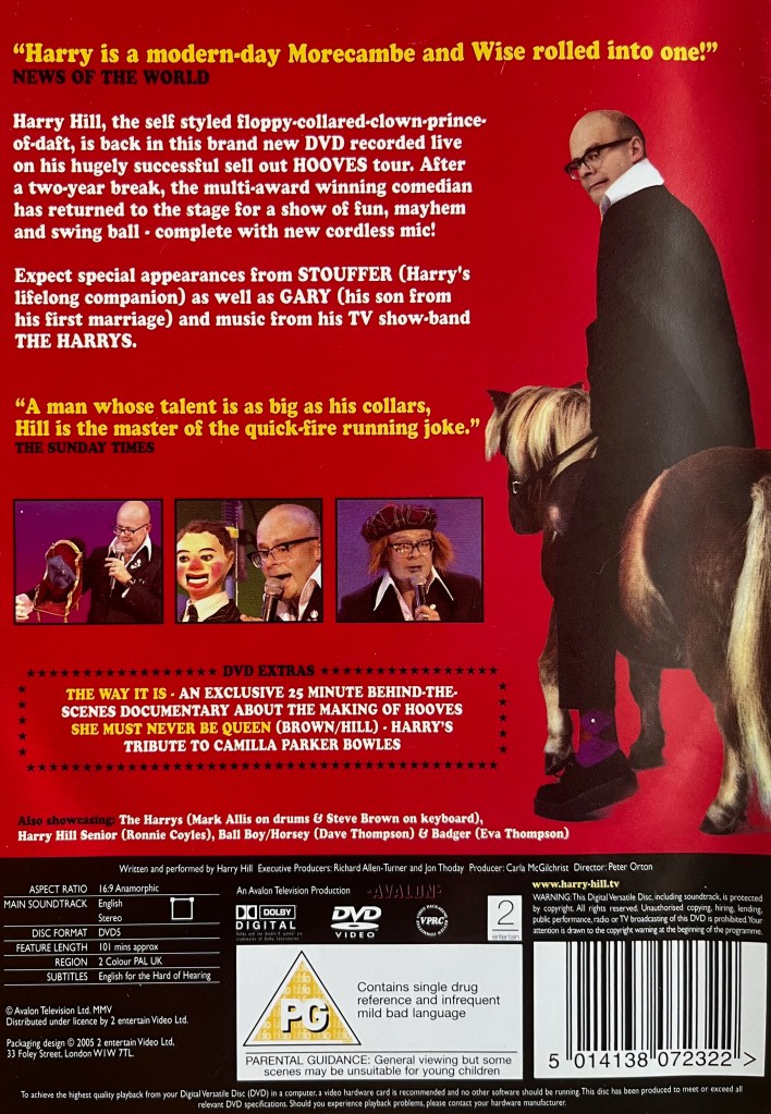 Back cover of Harry Hill's Hooves DVD, which has a red background. It shows a few images from the show below the description, including Harry with his puppets Stouffer the cat and Gary, and an image of him wearing a tartan hat over a ginger wig. To the right of the description is a taller photo of Harry riding a small horse, which is facing into the distance, as he looks over his shoulder at us with an anxious expression.