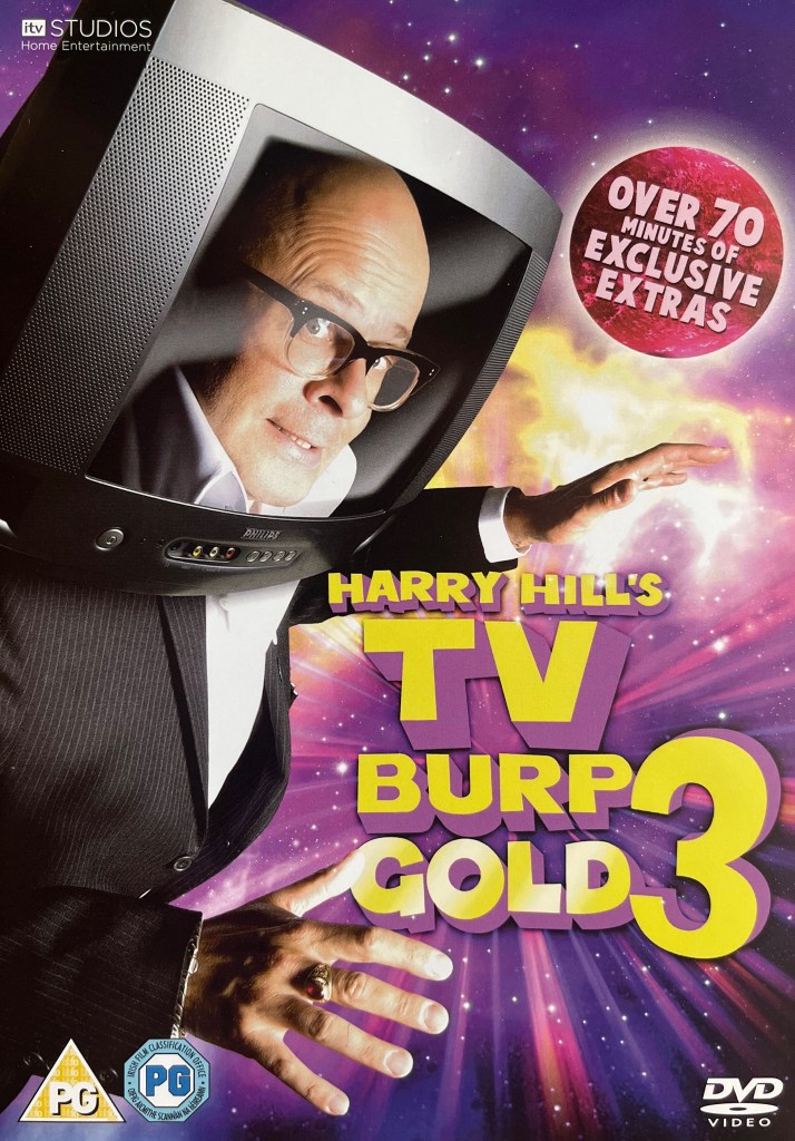 Front cover of the DVD for Harry Hill's TV Burp Gold 3. It shows Harry wearing a TV set like an astronaut's helmet as he floats through a colourful area of space, which has a vibrant mix of white, yellow, purple and pink colours. The title is shown in large yellow letters at the bottom right of the cover.