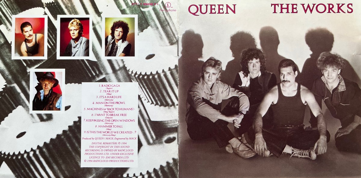 Cover spread for Queen's album The Works. The front cover on the right shows the 4 band members sitting together on the floor. From left to right, we see Roger, Brian, Freddie and John, alternating between the front and back of the shot. The back cover on the left has a background of large metal machine cogs, over which are individual portrait photos of each of the band members with white borders, and a white panel listing the tracks on the album.