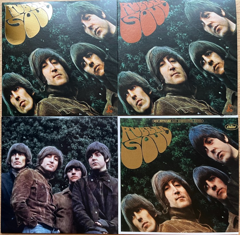 Front covers of the cardboard disc sleeves in the box set of the Beatles album Rubber Soul. The first 2 cases show the album cover, with the 4 members of the band presented in a curved formation from bottom left to top right, against a green leafy background. The title of the album is in bulging letters in the top left. On the first case the title is in reflective gold lettering, while on the second case the title is printed in red. The 4th case also shows the album cover, but the title is in brown, there is a Capitol Records logo in the top right corner, and there is a white border around the edge of the case. The third case, meanwhile, shows a different photo of the band, now standing in a straight line against the green leafy background, and there is no title.