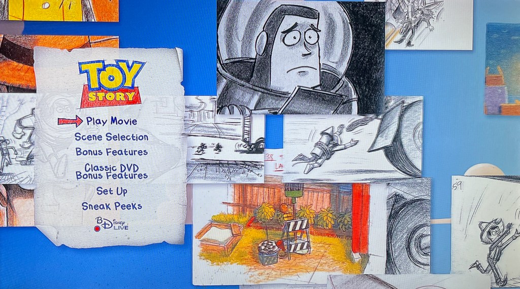 The Blu-ray menu for the first Toy Story film. The background is filled with black and white drawings and colourful sketches that were created by hand while designing the film, including images of Buzz and Woody. The various menu options are presented on a slightly crumpled piece of notepaper on the left of the screen. The options include Play Movie, Scene Selection, Bonus Features, Classic DVD Bonus Features, Set Up, Sneak Peeks and Disney BD Live.